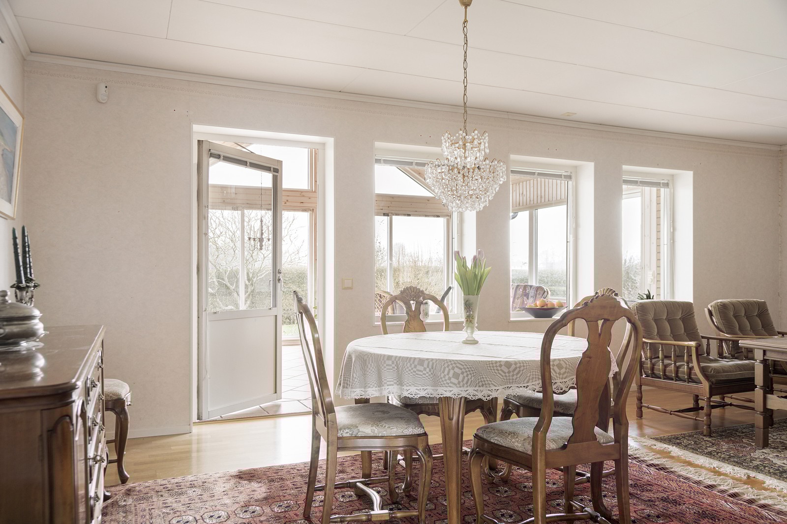 Med dörren på glänt mot det vinterbonade tillbyggda allrummet