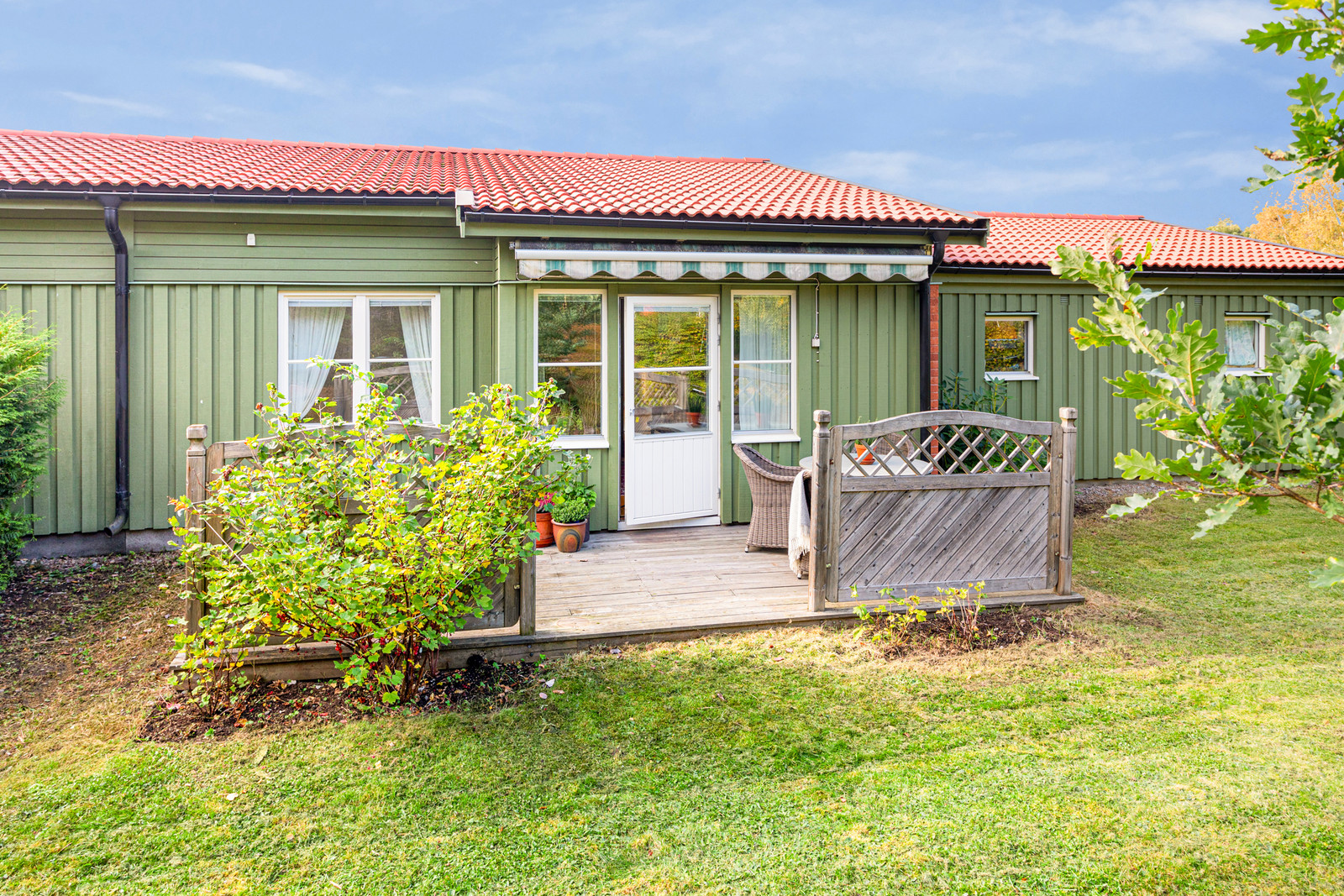 Altan och gräsytor i skyddat läge på husets baksida